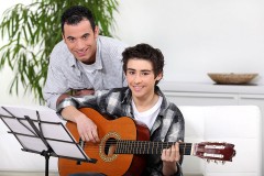 a guitar instructor and a student